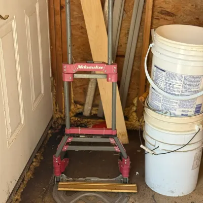 Sale Photo Thumbnail #233: Milwaukee folding hand truck cart with red and gray metal frame, showing signs of light use.