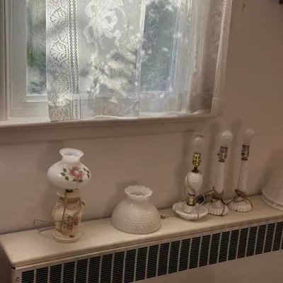 Sale Photo Thumbnail #22: Collection of vintage milk glass lamps and shade, including a hand-painted floral hurricane lamp and hobnail glass pieces.