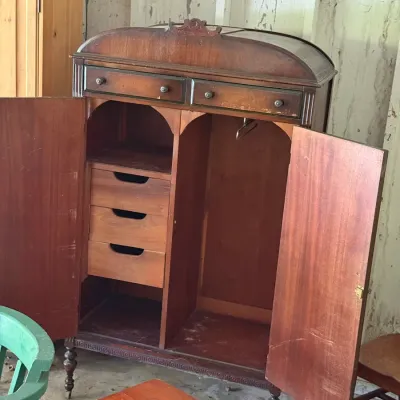 Sale Photo Thumbnail #282: Vintage dark wood gentleman's wardrobe, featuring an arched top crest, upper drawers, internal fitted drawers, and hanging rod section.