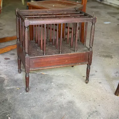 Sale Photo Thumbnail #267: Vintage dark stain wooden magazine rack featuring turned spindle dividers and spiral-carved corner posts.