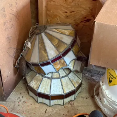 Sale Photo Thumbnail #223: Vintage Tiffany-style stained glass hanging light fixture with cream, amber, and red leaded panels, stored on the floor.