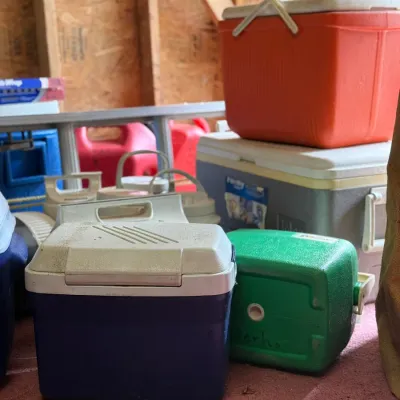 Sale Photo Thumbnail #216: Assortment of vintage plastic coolers in various colors and sizes, including blue, green, orange, and white models.