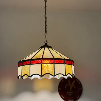 Sale Photo Thumbnail #43: Vintage Tiffany-style stained glass pendant light with cream and red slag glass panels, suspended from a dark metal chain.