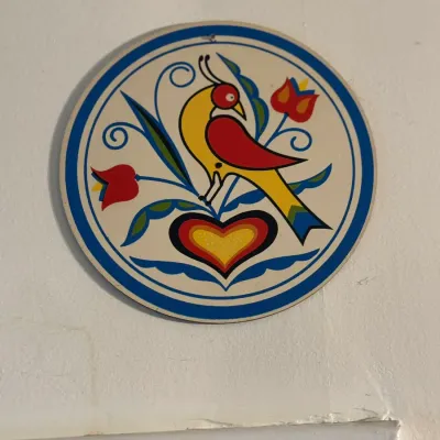 Sale Photo Thumbnail #169: Vintage Pennsylvania Dutch style hex sign featuring a distelfink bird, heart, and floral motifs within a circular blue border.