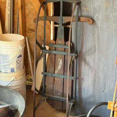 Sale Photo Thumbnail #235: Vintage Flexible Flyer style wooden snow sled with metal runners, showing rustic wear.