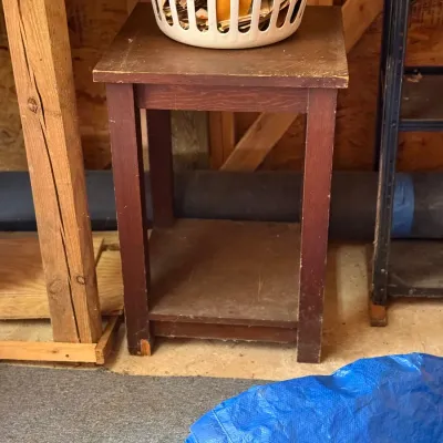 Sale Photo Thumbnail #225: Vintage dark stain wooden side table featuring a lower shelf, showing visible surface wear and scuffing from use.