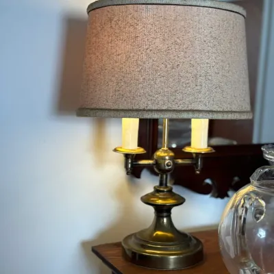 Sale Photo Thumbnail #12: Vintage brass two-light boudoir or table lamp featuring faux candle covers and a textured drum shade.