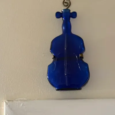 Sale Photo Thumbnail #157: Cobalt blue glass violin-shaped bottle hanging decor with embossed details.
