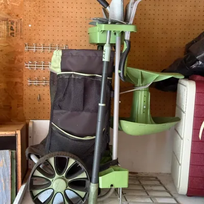 Sale Photo Thumbnail #232: Rolling garden tool caddy cart with various hand tools, including trowels and a cultivator, in good used condition.