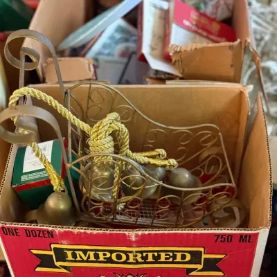Sale Photo Thumbnail #57: Vintage brass wire decorative sleigh filled with gold corded jingle bells, packed in a cardboard box.