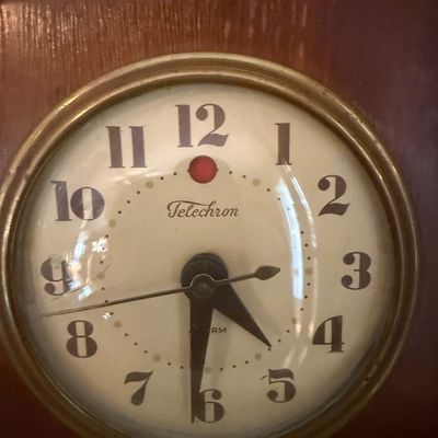 Sale Photo Thumbnail #69: Vintage Telechron electric alarm clock in a wooden case, featuring a round white face with bold Arabic numerals.