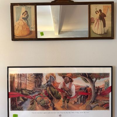 Sale Photo Thumbnail #18: Two framed wall pieces, including a vintage tri-fold mirror with romantic illustrations and a framed narrative poster depicting two men building a bridge across a river.