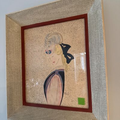 Sale Photo Thumbnail #72: Mid-century framed fashion illustration print depicting a profile of a woman with styled hair and a large bow. Presented in a textured woven frame with a red inner mat.