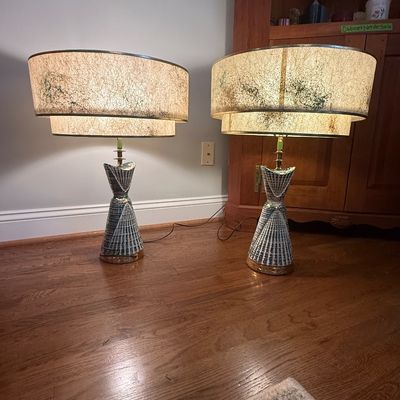 Sale Photo Thumbnail #56: Pair of mid-century modern ceramic table lamps featuring atomic textured bases with blue accents and original tiered fiberglass shades.