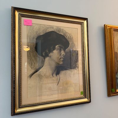 Sale Photo Thumbnail #41: Framed charcoal portrait drawing of a figure wearing a cap, housed in an ornate gold and dark wood frame with matting.