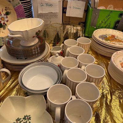 Sale Photo Thumbnail #14: Large collection of holiday-themed dinnerware and glassware, featuring striped mugs, Christmas tree tall glasses, holly berry bowls, and stacked plates.