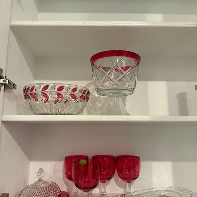 Sale Photo Thumbnail #8: Collection of ruby stain glass serverware, including a pedestal bowl, patterned bowl, covered butter dish, tray, and four goblets.