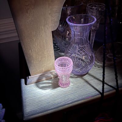 Sale Photo Thumbnail #81: Collection of vintage cut and pressed glass items, featuring a pink glass toothpick holder or small vase glowing under blacklight alongside cut crystal vases.