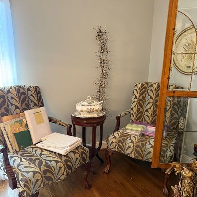 Sale Photo Thumbnail #21: Pair of Queen Anne style armchairs upholstered in a gold and brown feather pattern, featuring carved wood legs and ball-and-claw feet.
