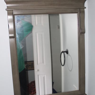 Sale Photo Thumbnail #35: Modern grey-stained wood vanity mirror featuring crown molding and decorative side corbels.