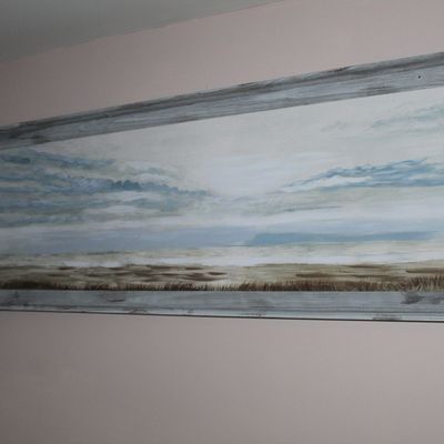 Sale Photo Thumbnail #17: Large panoramic landscape painting depicting a coastal scene, framed in a distressed rustic grey wood frame.