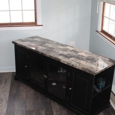 Sale Photo Thumbnail #28: Contemporary black media console with a faux marble polished top, featuring central glass-front cabinet doors and end storage compartments.