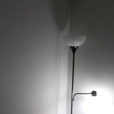 Sale Photo Thumbnail #77: Black metal Torchiere floor lamp featuring a frosted white bowl shade and an attached adjustable reading arm light.