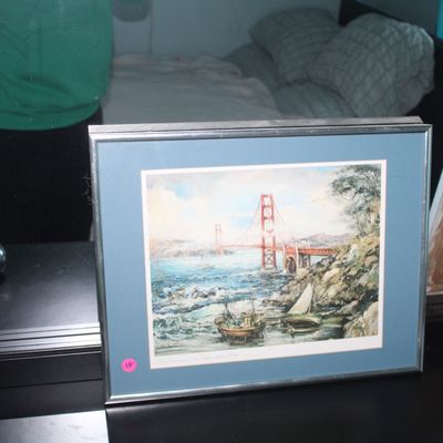 Sale Photo Thumbnail #84: Framed watercolor print of the Golden Gate Bridge, matted in blue with a silver metal frame.