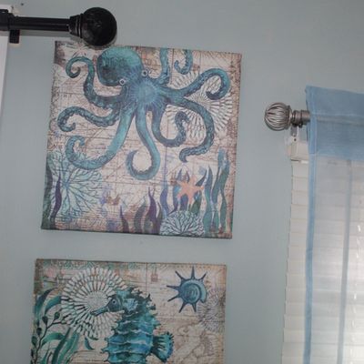 Sale Photo Thumbnail #25: Pair of contemporary square canvas wall art prints featuring blue marine life motifs including an octopus and a seahorse.