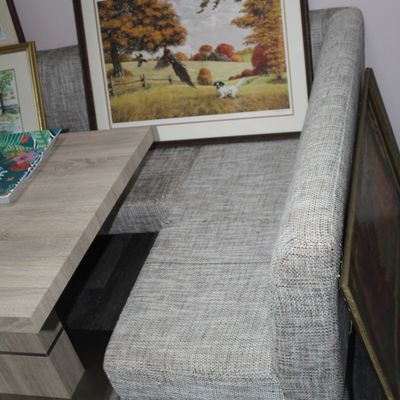 Sale Photo Thumbnail #12: Modern grey tweed upholstered dining banquette booth alongside a light wood laminate table, displayed with framed artwork.