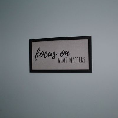 Sale Photo Thumbnail #90: Framed wall art featuring the text 'focus on WHAT MATTERS' on a light textured background with a dark frame.