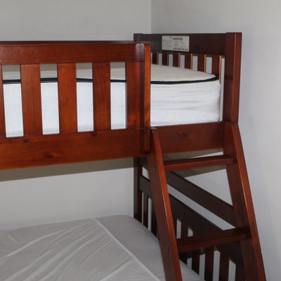 Sale Photo Thumbnail #79: Modern reddish-brown wooden bunk bed frame featuring a slatted top guardrail and built-in ladder.