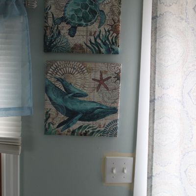Sale Photo Thumbnail #96: Pair of modern square canvas prints featuring nautical sea life motifs, including a sea turtle and whales against a map-style background.