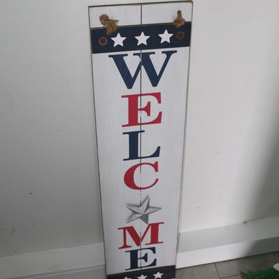 Sale Photo Thumbnail #37: Patriotic wooden 'WELCOME' porch sign with red, white, and blue lettering and a metal star accent.