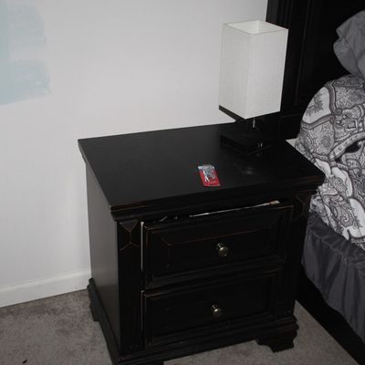 Sale Photo Thumbnail #68: Black two-drawer nightstand with round metal pulls, paired with a modern rectangular white box-shade table lamp.