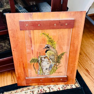 Sale Photo Thumbnail #33: Vintage wood panel wall plaque featuring a painted illustration of a woodpecker or bird on a tree stump.