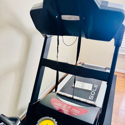 Sale Photo Thumbnail #48: Sole Fitness motorized treadmill with console, owner's manual, and protective floor mat.