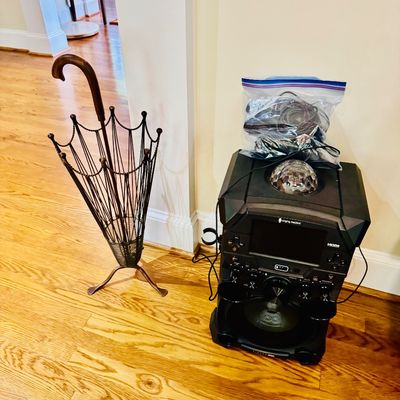 Sale Photo Thumbnail #19: Vintage wire umbrella-shaped umbrella stand alongside a modern Singing Machine karaoke system with disco light dome and bagged accessories.
