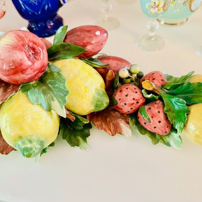 Sale Photo Thumbnail #35: Italian majolica glazed ceramic fruit-themed centerpiece, featuring detailed lemons, apples, and strawberries nestled among green leaves.