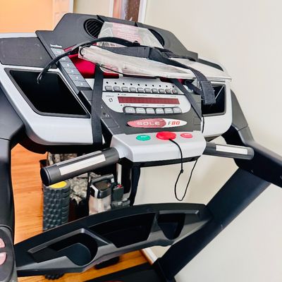 Sale Photo Thumbnail #46: Sole F80 folding treadmill featuring a digital console with built-in speakers, speed and incline controls, and a safety key.