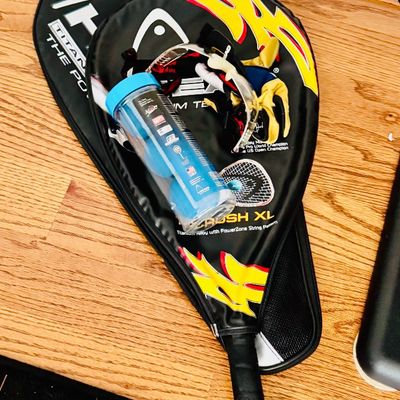 Sale Photo Thumbnail #39: Head brand racquetball set, including two rackets with protective padded cases, protective eyewear, gloves, and a canister of racquetballs.