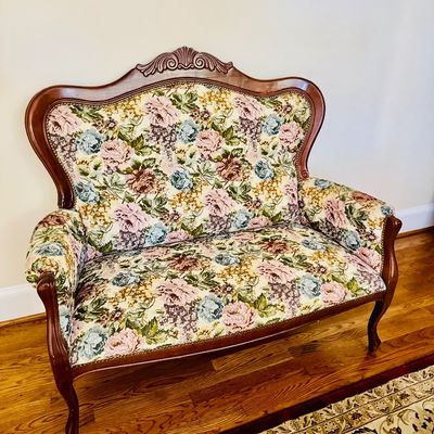 Sale Photo Thumbnail #2: Vintage French Provincial style loveseat featuring a carved wooden frame and floral tapestry upholstery.