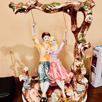 Sale Photo Thumbnail #53: Vintage ceramic figurine featuring a couple on a tree swing, hand-painted with holly accents and detailed tree-branch arch.