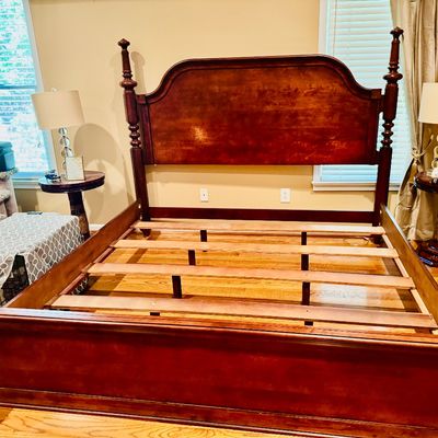 Sale Photo Thumbnail #66: Traditional wooden four-poster bed frame featuring turned finials, an arched headboard, and wooden slats.
