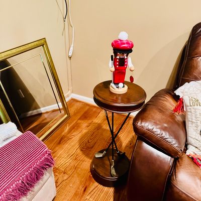 Sale Photo Thumbnail #54: Novelty golf-themed side table with crossed golf club legs, topped with a golfer nutcracker figure.