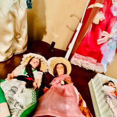 Sale Photo Thumbnail #57: Collection of vintage costume dolls, featuring traditional European regional attire and straw hats.