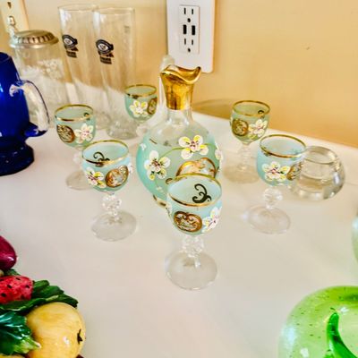 Sale Photo Thumbnail #38: Vintage Venetian Bohemian light blue glass decanter set with hand-painted floral enameling and gold gilt accents, accompanied by matching cordial glasses.