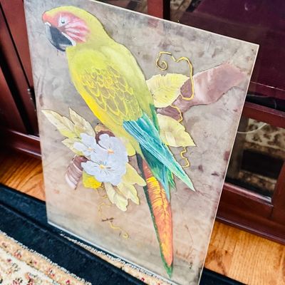 Sale Photo Thumbnail #32: Vintage reverse-painted glass panel featuring a colorful parrot perched on a branch with white blossoms.