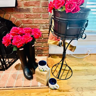Sale Photo Thumbnail #20: Black Hunter rain boots holding artificial red roses displayed beside a wrought iron plant stand and boxed Starbucks 'Been There Series' mugs.