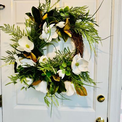 Sale Photo Thumbnail #6: Large faux floral door wreath featuring white magnolia blossoms, greenery, and ferns on a natural grapevine base.